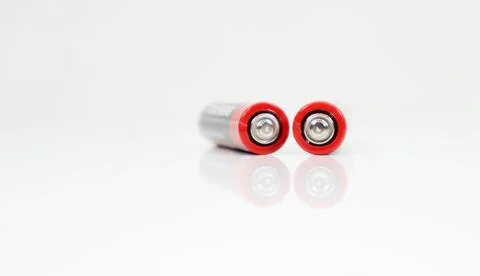 Two type AAA alkaline rechargeable batteries on white glossy background with Stock-Fotos