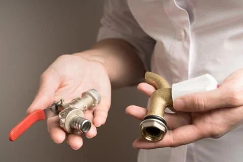 Two types of cranes in the hands, valve and ball. Stock Photos