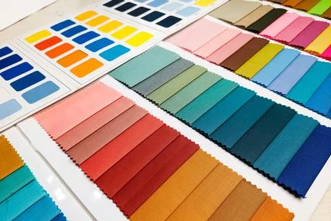 Two types of fabric catalogs featuring various colors. Stock Photos