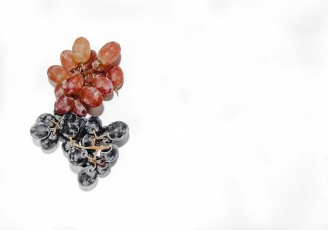 Two types of grapes on a white background with a place for tex Stock Photos