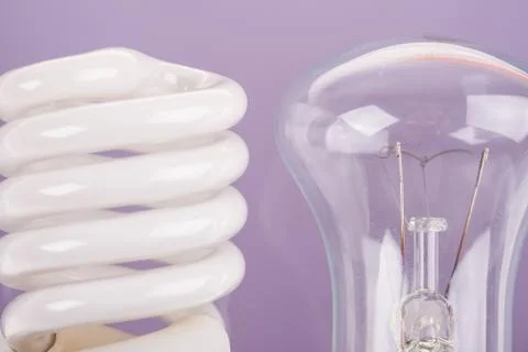 Two types of light bulbs on blue background Stock Photos