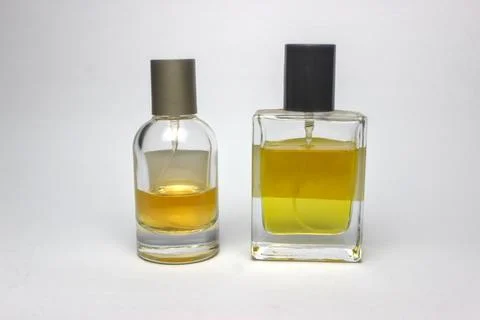 Two types of perfume bottles with different designs on a white background. 스톡 사진
