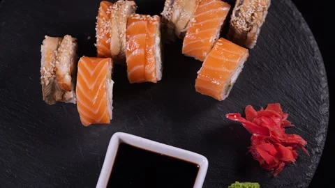 Two types of sushi rolls with ginger, wasabi and soy sauce. Stock-Footage 311718624