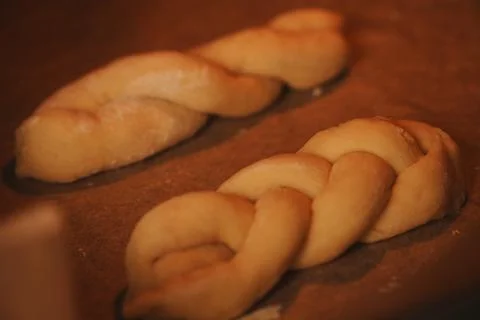 Two Uncooked Braided Bread Twists on Parchment Paper Ready for Homemade Bak.. Stock Photos