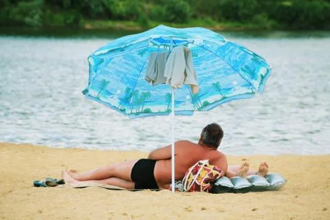 Two under a sunshade Stock Photos