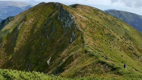 Two unidentified men walk the path to the mountains in Tatras, Slovakia Video stock 77277057