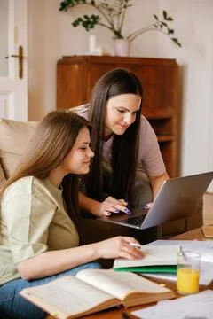 Two university students doing homework together and helping each other sitting Stock Photos