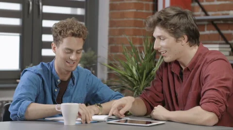 Two university students working on project together in loft modern interior Vidéo 67671695