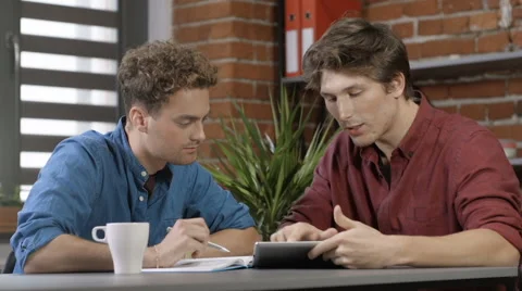 Two university students working on project together in loft modern interior 動画素材 67672576