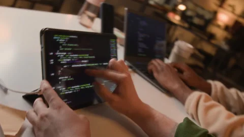 Two Unknown Software Developers Coding on Tablet and Laptop in Office Stock Footage 336711724