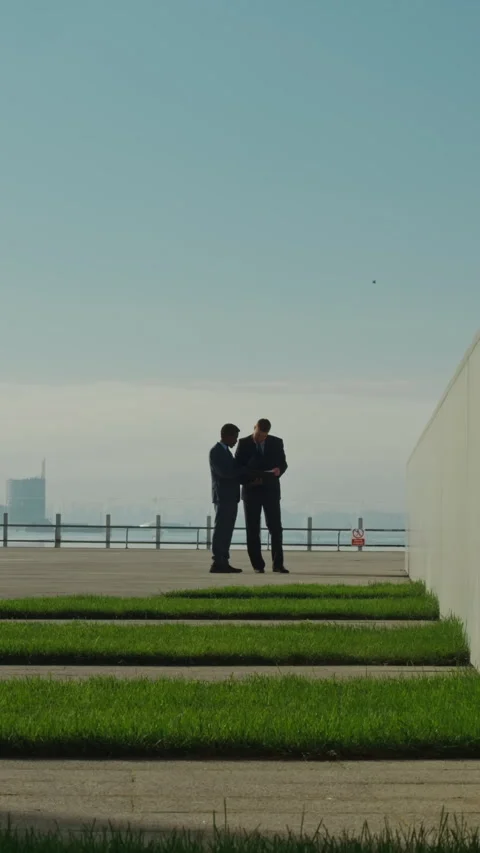 Two Unrecognizable Male Executives Looking Through Paper Documents Outside Stock Footage 303628169