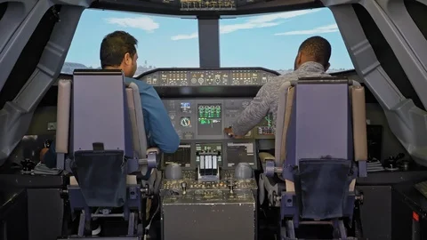 Two unrecognized multi-racial men in the airliner cockpit. Training simulator Stock Footage 125324126