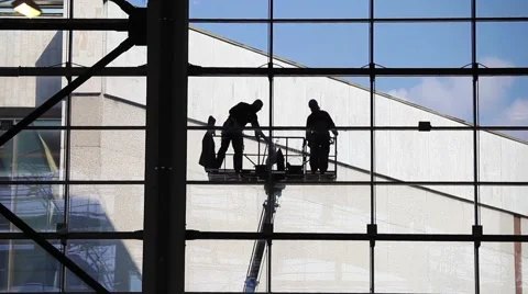 Two unrecognized washers washing windows.Industrial Climbers, facade cleaning Stock Footage 52583116