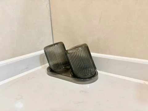 Two Upside Down Ribbed Glasses on Bathroom Countertop Stock Photos