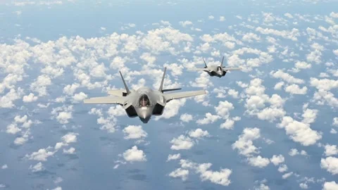 Two U.S. Air Force F-35A Lightning II's peel away above clouds Stock Footage 201245262