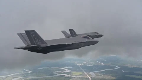 Two U.S. Air Force F-35's flying through storm clouds Stock Footage 253997978