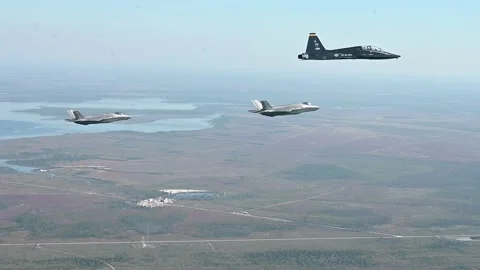 Two U.S. Air Force F-35A Lightning II's flying with T-38C Talon aircraft Stock Footage 255283915