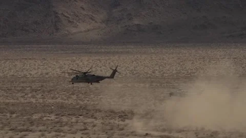 Two U.S. Marines CH-53 Super Stallion helicopters create duststorm in desert Stock Footage 233882988