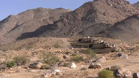 Two U.S. Tanks Backing up After Shooting in a Desert Stock Footage 130361239