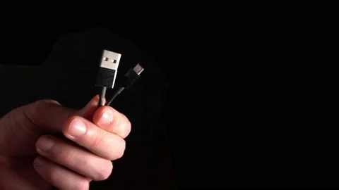 Two USB connectors in hand on a black background Stock-Footage 144841632