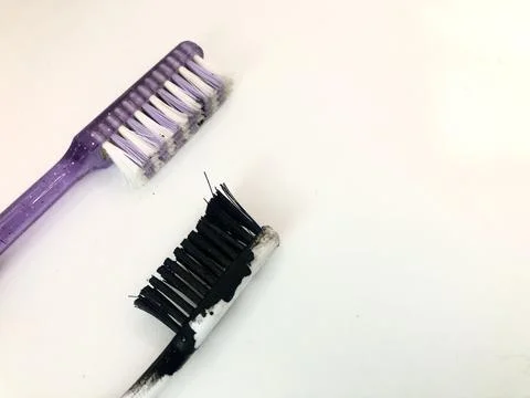 Two used toothbrushes side by side clean and dirty Stock Photos