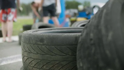 Two used wheels lying on the road one on top of the other close-up shot Stock Footage 129345856