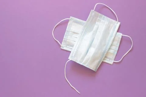 Two used white torn virus protection masks Stock Photos