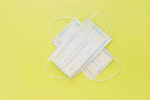 Two used white torn virus protection masks Stock Photos