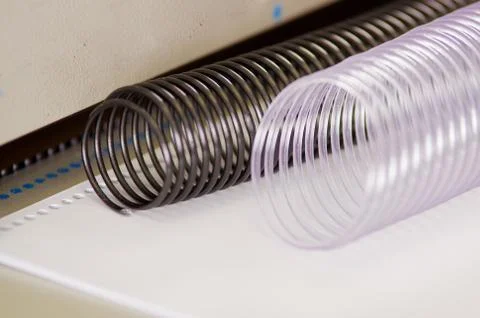 Two useful plastic binding combs white and black on a Binding machine Stock Photos