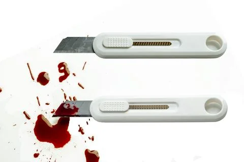 Two utility knives on a white background, one clean and one covered in bloo.. Stock Photos