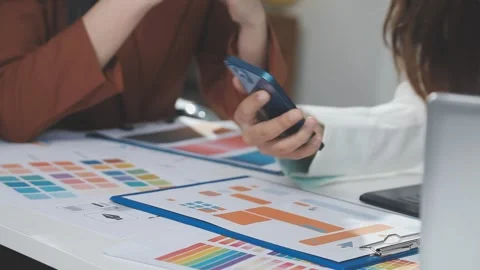 Two UX UI designers brainstorming mobile app wireframes in a modern startup.. Stock Footage 321352982