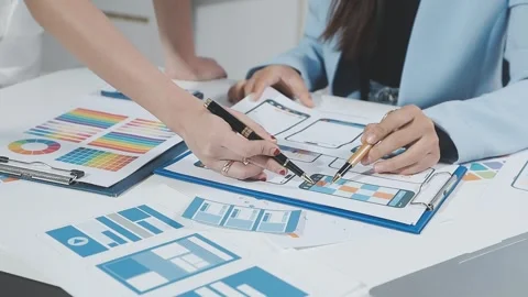 Two UX UI designers brainstorming mobile app wireframes in a modern startup.. Stock Footage 321353045