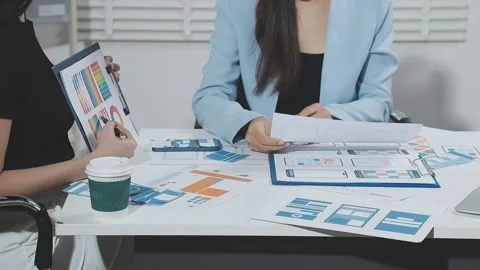 Two UX UI designers brainstorming mobile app wireframes in a modern startup.. Stock Footage 321353051