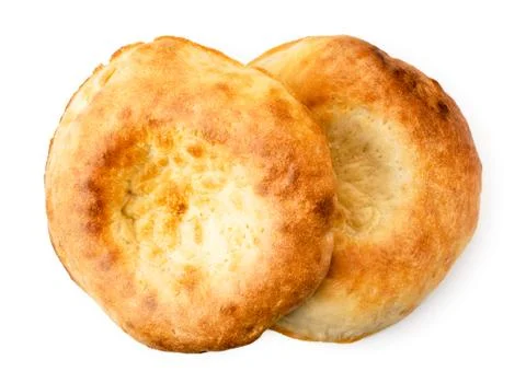 Two Uzbek flat cake on a white. The form of the top. Stock Photos