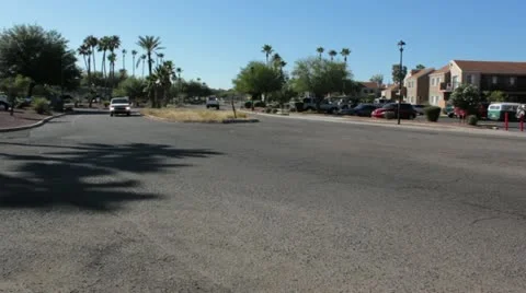 Two Vehicles Pass on Small Divided Road in City Vídeo Stock 12202955