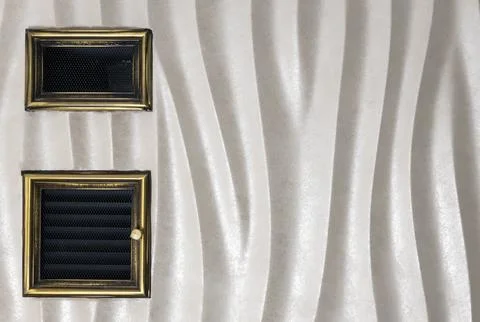 Two ventilation grilles in the wall. The concept of the air ventilation system 库存照片