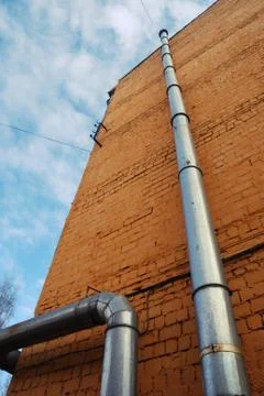 Two ventilation pipes on a brick wall Stock Photos
