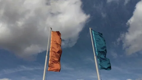 Two vertical flags waving in the cloudy sky Stock Footage 107774538