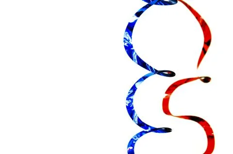 Two vertically hanging shiny festive ribbons of blue and red colors Stock Photos