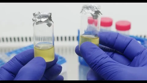 Two vials of yellow liquid Stock Footage 308242977
