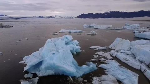 Two views of Icebergs floating in a flat pond in Iceland - Diamond Beach Stock Footage