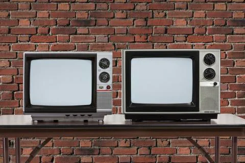 Two Vintage Televisons with Brick Wall Stock Photos