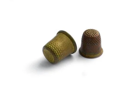 Two vintage thimbles isolated on a white background with shadow. Stock Illustration