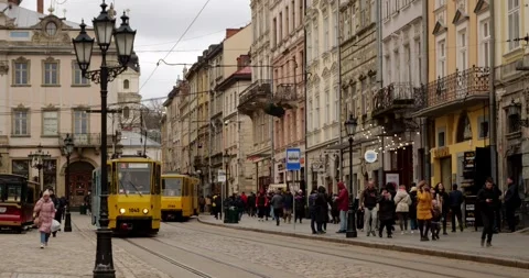 Two vintage trams move through the ancient beautiful city with architecture Stock Footage 240106699