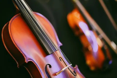 Two violins on some chairs Stock Photos