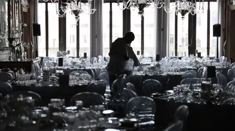 Two waiters setting up the dining room for the evening event Stock Footage 50551305