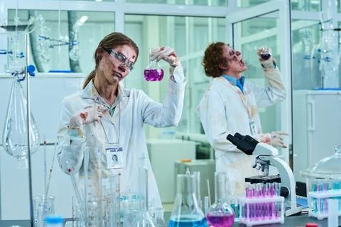 Two Walking Dead Lab Technicians in Bloody Coats Working with Reagents Stock Photos