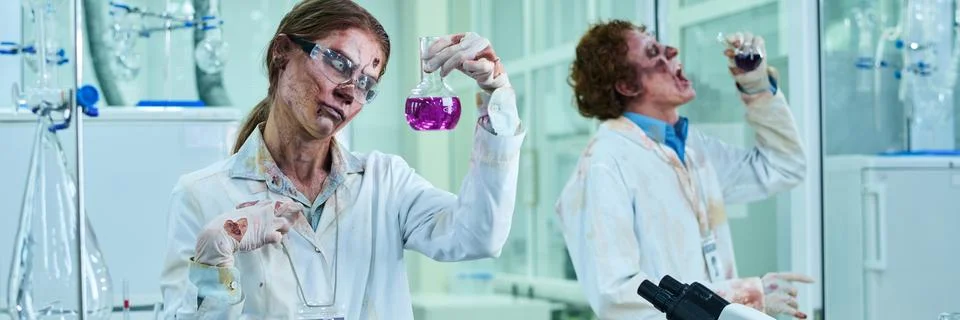 Two Walking Dead Lab Technicians in Bloody Coats Working with Reagents Header Stock Photos
