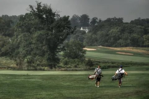 Two Walking Golfers Stock Photos