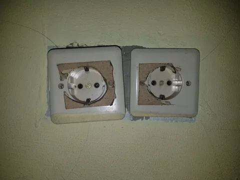Two wall sockets attached to the wall Stock Photos